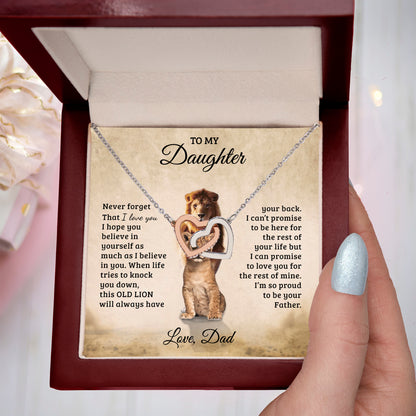 Necklace with lion design and sentimental message in a box, held by a hand.