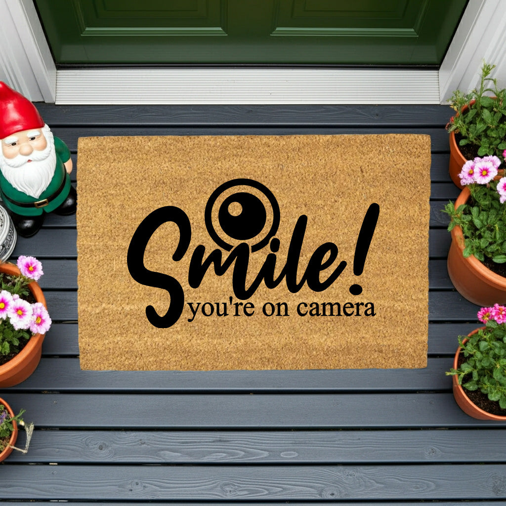 “Smile! You’re on Camera” Funny Security Doormat | Coir Welcome Mat for Home Surveillance | Humorous Front Porch Décor - Mallard Moon