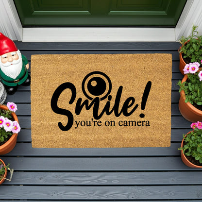“Smile! You’re on Camera” Funny Security Doormat | Coir Welcome Mat for Home Surveillance | Humorous Front Porch Décor - Mallard Moon