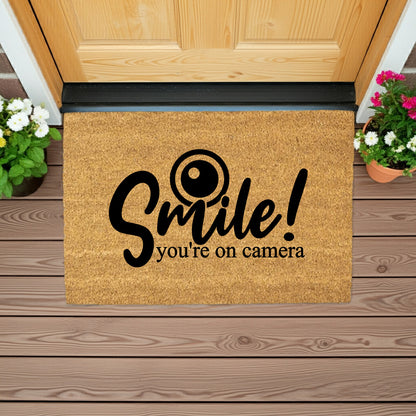 “Smile! You’re on Camera” Funny Security Doormat | Coir Welcome Mat for Home Surveillance | Humorous Front Porch Décor - Mallard Moon