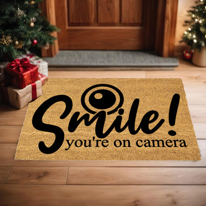 “Smile! You’re on Camera” Funny Security Doormat | Coir Welcome Mat for Home Surveillance | Humorous Front Porch Décor - Mallard Moon