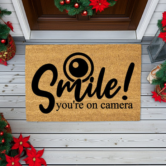 “Smile! You’re on Camera” Funny Security Doormat | Coir Welcome Mat for Home Surveillance | Humorous Front Porch Décor - Mallard Moon